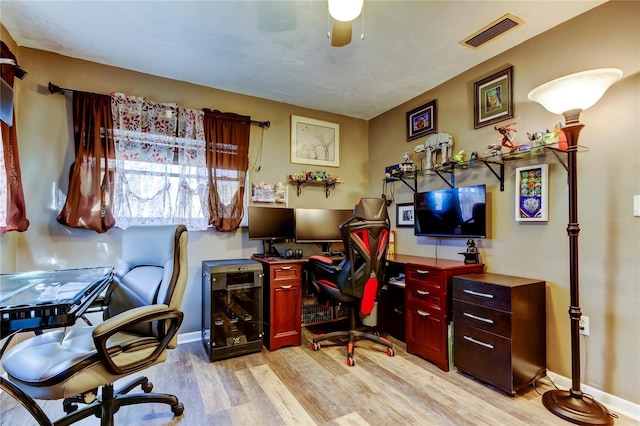 home office featuring ceiling fan and light hardwood / wood-style floors