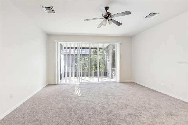 empty room featuring carpet floors and ceiling fan