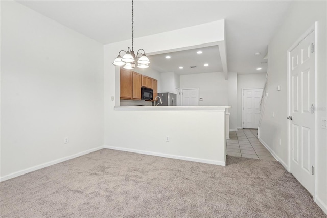 kitchen with an inviting chandelier, hanging light fixtures, stainless steel fridge, light colored carpet, and kitchen peninsula