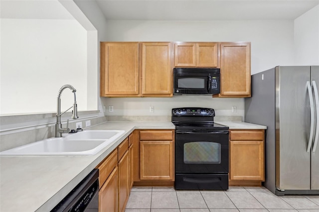 kitchen featuring sink, light tile patterned floors, and black appliances