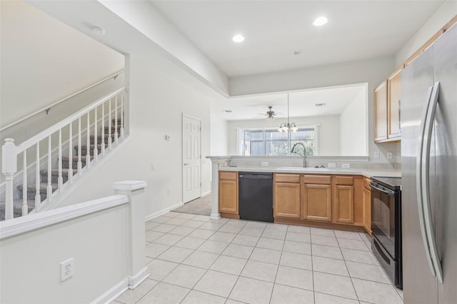 kitchen featuring black appliances, sink, ceiling fan, decorative light fixtures, and kitchen peninsula