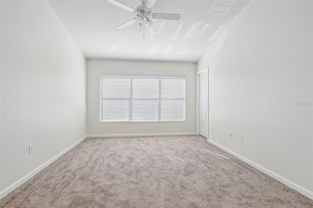 carpeted spare room featuring ceiling fan