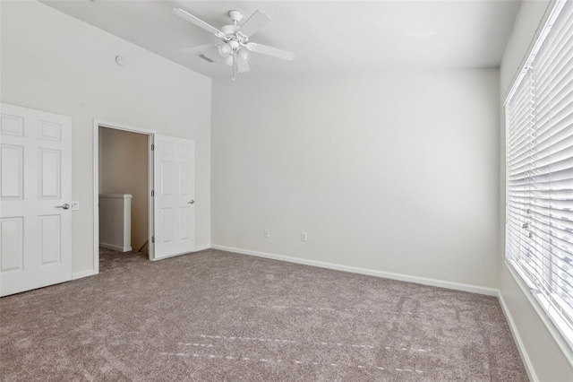 unfurnished bedroom with multiple windows, ceiling fan, and carpet floors