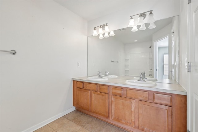 bathroom with tile patterned flooring, vanity, and walk in shower