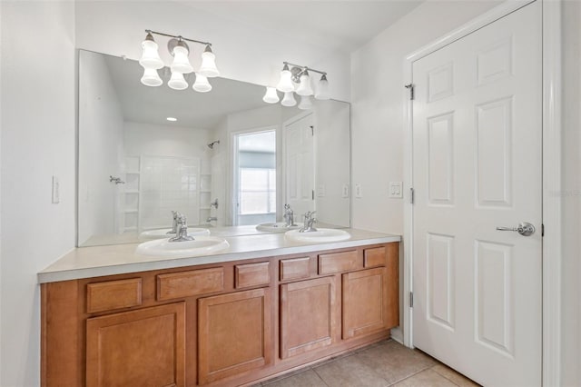 bathroom featuring tile patterned flooring, vanity, and walk in shower