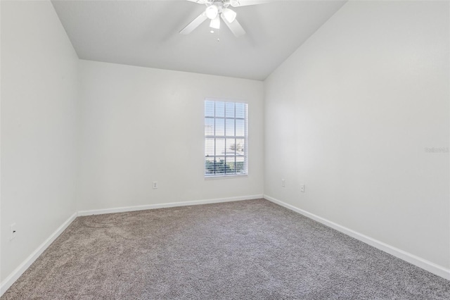 empty room featuring carpet floors, vaulted ceiling, and ceiling fan