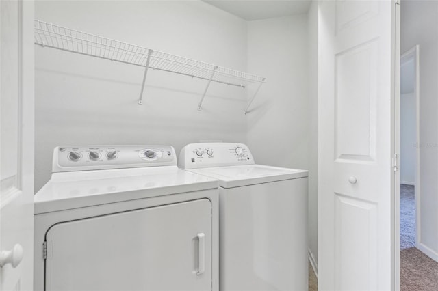 laundry room featuring washing machine and clothes dryer and carpet