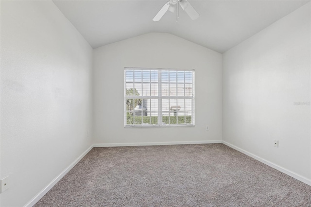 empty room with ceiling fan, carpet floors, and lofted ceiling