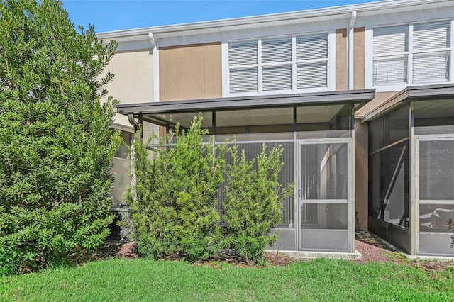 rear view of house featuring a sunroom