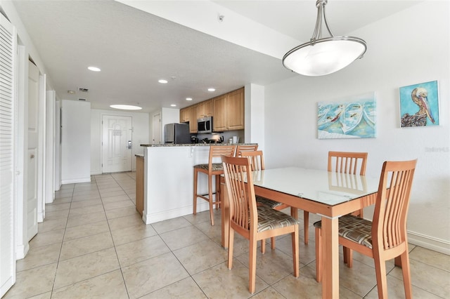 11605 Gulf Blvd Unit 507, Treasure Island, FL 33706 - dining room with recessed lighting, baseboards, and light tile patterned flooring
