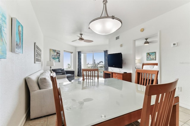 tiled dining space with ceiling fan