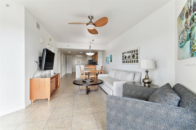 tiled living room with ceiling fan