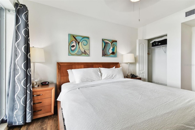 bedroom featuring ceiling fan, a closet, and dark hardwood / wood-style floors