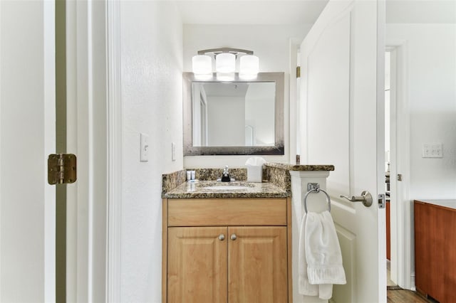 bathroom with hardwood / wood-style floors and vanity