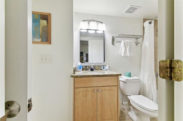 bathroom with a shower with shower curtain, a textured ceiling, vanity, tile patterned flooring, and toilet