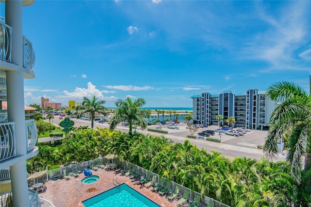 view of swimming pool with a water view and a patio