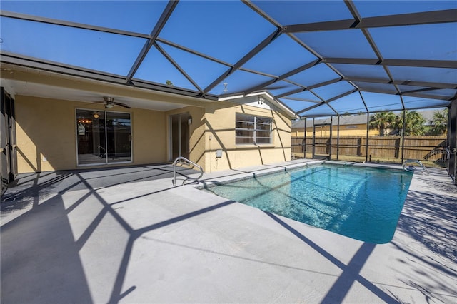 view of pool featuring ceiling fan, a patio, and glass enclosure