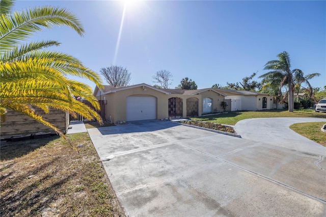 ranch-style home with a garage and a front lawn