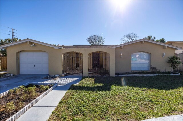 ranch-style home with a garage and a front lawn