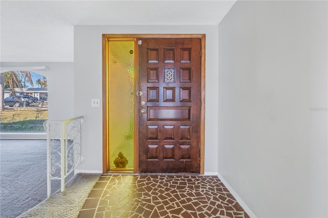 foyer entrance featuring a textured ceiling