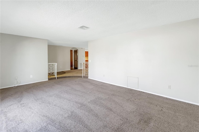 unfurnished room featuring carpet floors and a textured ceiling