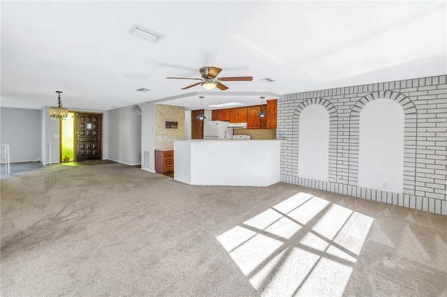 unfurnished living room with ceiling fan and light colored carpet