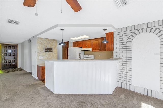 kitchen featuring white appliances, kitchen peninsula, light colored carpet, and hanging light fixtures