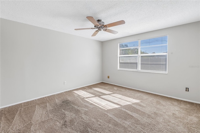 carpeted empty room featuring ceiling fan and a textured ceiling