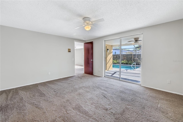 carpeted spare room with ceiling fan and a textured ceiling