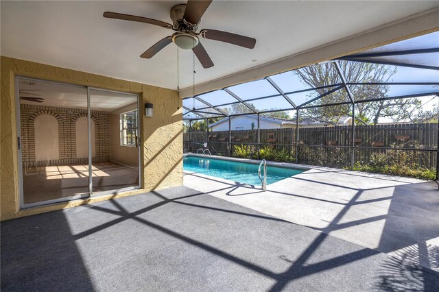 view of pool featuring a lanai, ceiling fan, and a patio area