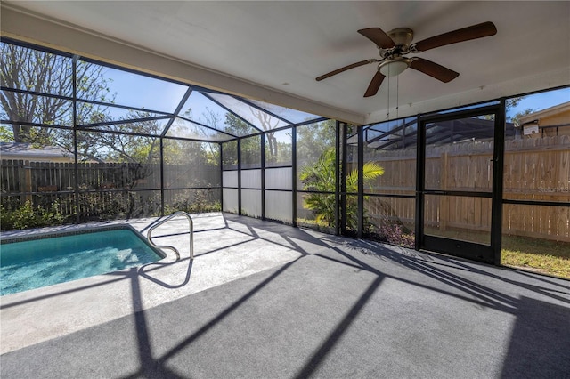 view of swimming pool featuring a lanai, a patio area, and ceiling fan