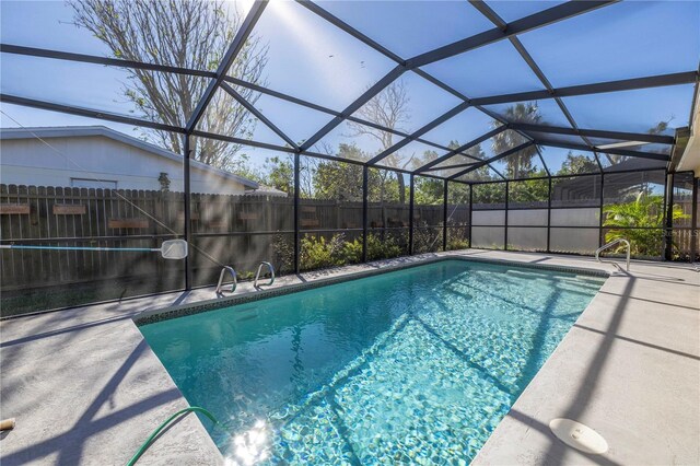 view of pool with a lanai and a patio