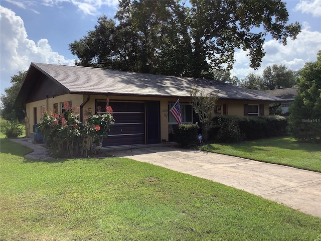 ranch-style house with a garage and a front yard