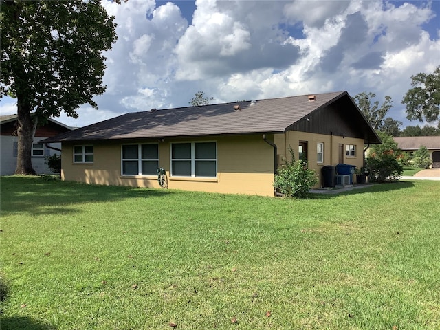 rear view of property featuring a yard