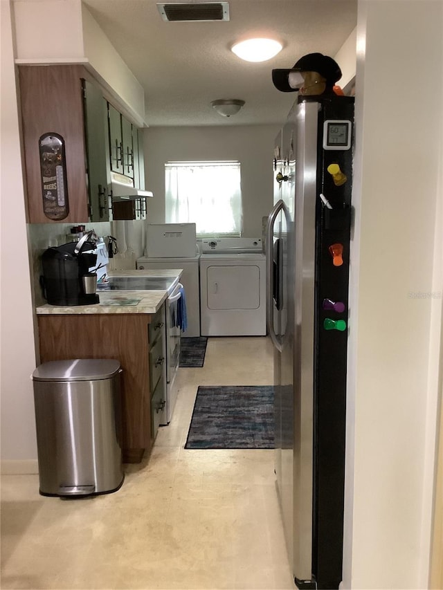 clothes washing area featuring washer and clothes dryer