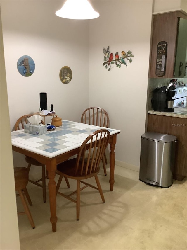 dining space featuring light colored carpet