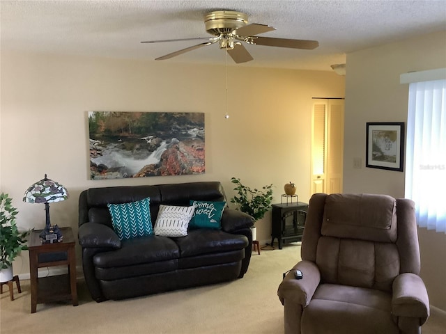 carpeted living room featuring ceiling fan, a wood stove, and a textured ceiling