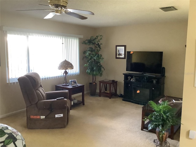 carpeted living room featuring ceiling fan