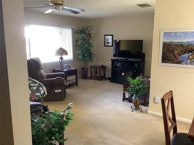 carpeted living room featuring ceiling fan