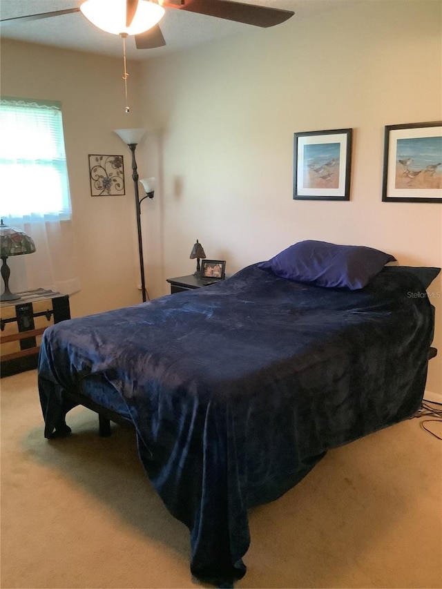 bedroom with ceiling fan and light colored carpet