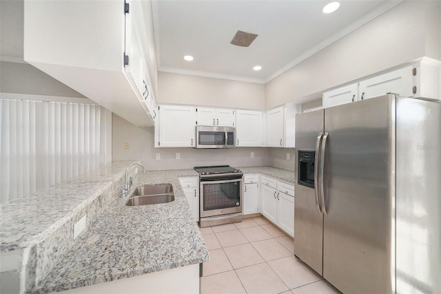 kitchen with light stone counters, white cabinetry, sink, and appliances with stainless steel finishes