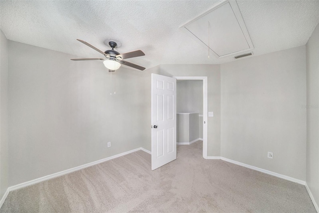 unfurnished bedroom with light carpet, a textured ceiling, and ceiling fan