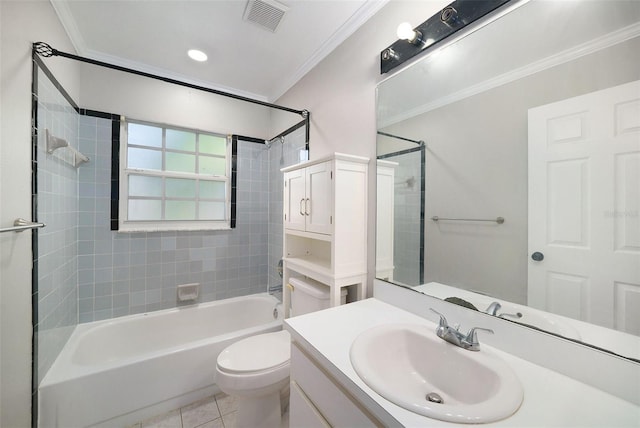 full bathroom featuring vanity, crown molding, tile patterned flooring, tiled shower / bath combo, and toilet