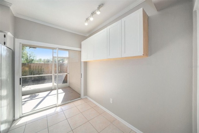 interior space with light tile patterned flooring and ornamental molding