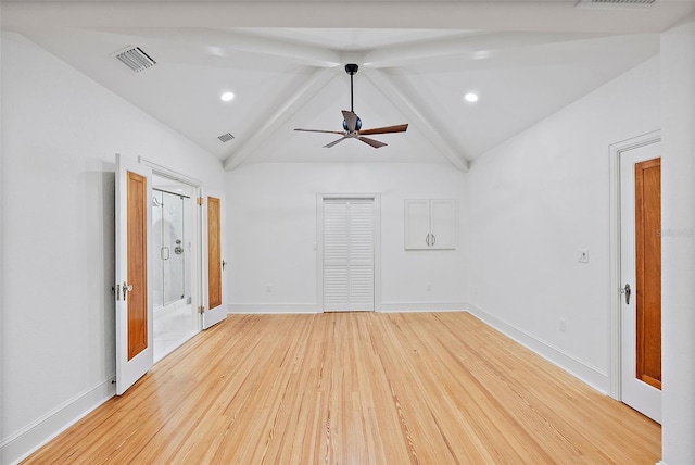 empty room featuring ceiling fan, lofted ceiling, and light hardwood / wood-style floors