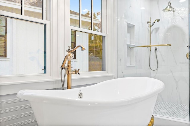 bathroom featuring independent shower and bath and sink