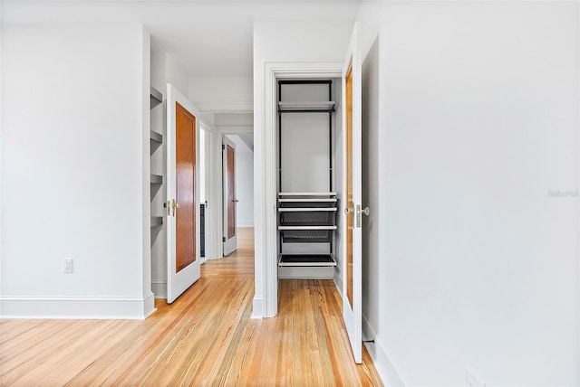 corridor with light wood-type flooring