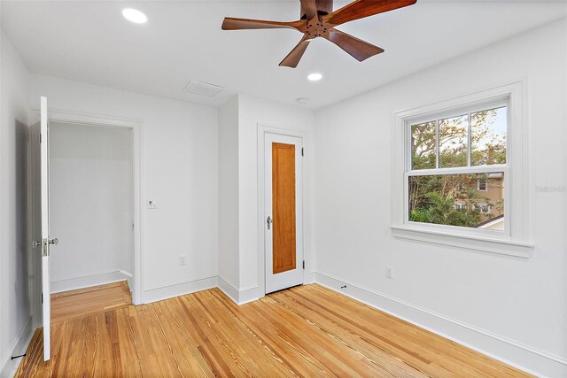 unfurnished bedroom with ceiling fan and light hardwood / wood-style flooring