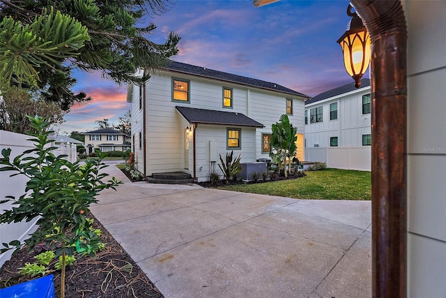 back house at dusk with a yard