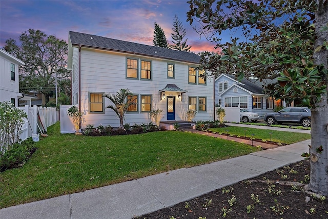 colonial house featuring a lawn